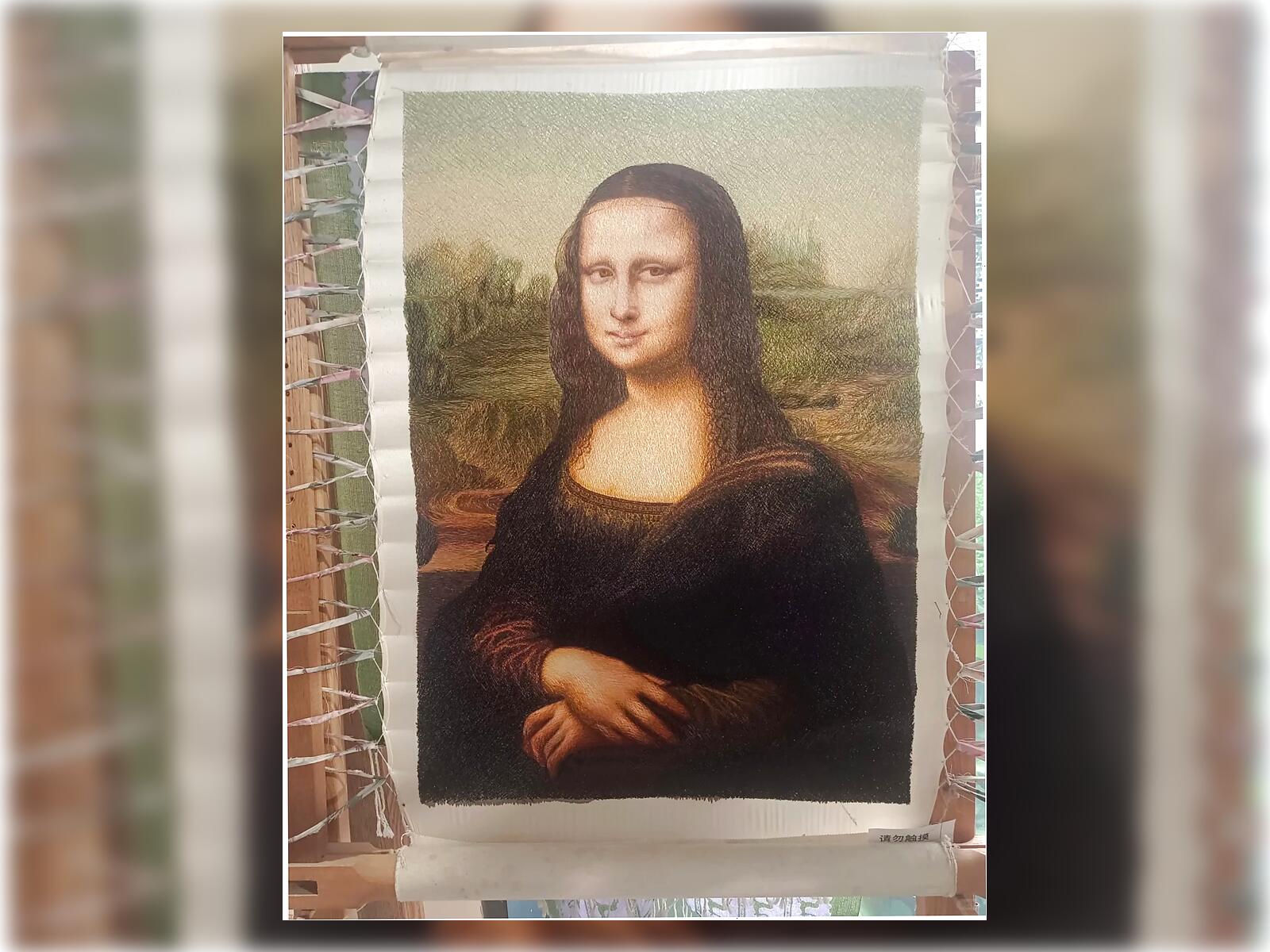 Handmade Mona Lisa random-stitch embroidery by Orient Handcraft, showing layered silk threads in the face, hair, and background