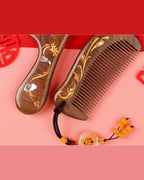 Black Sandalwood Dragon and Phoenix wooden combs with mother-of-pearl inlay on a red and pink background.
