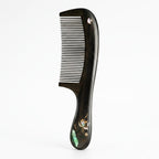 Black comb with decorative handle on a white background