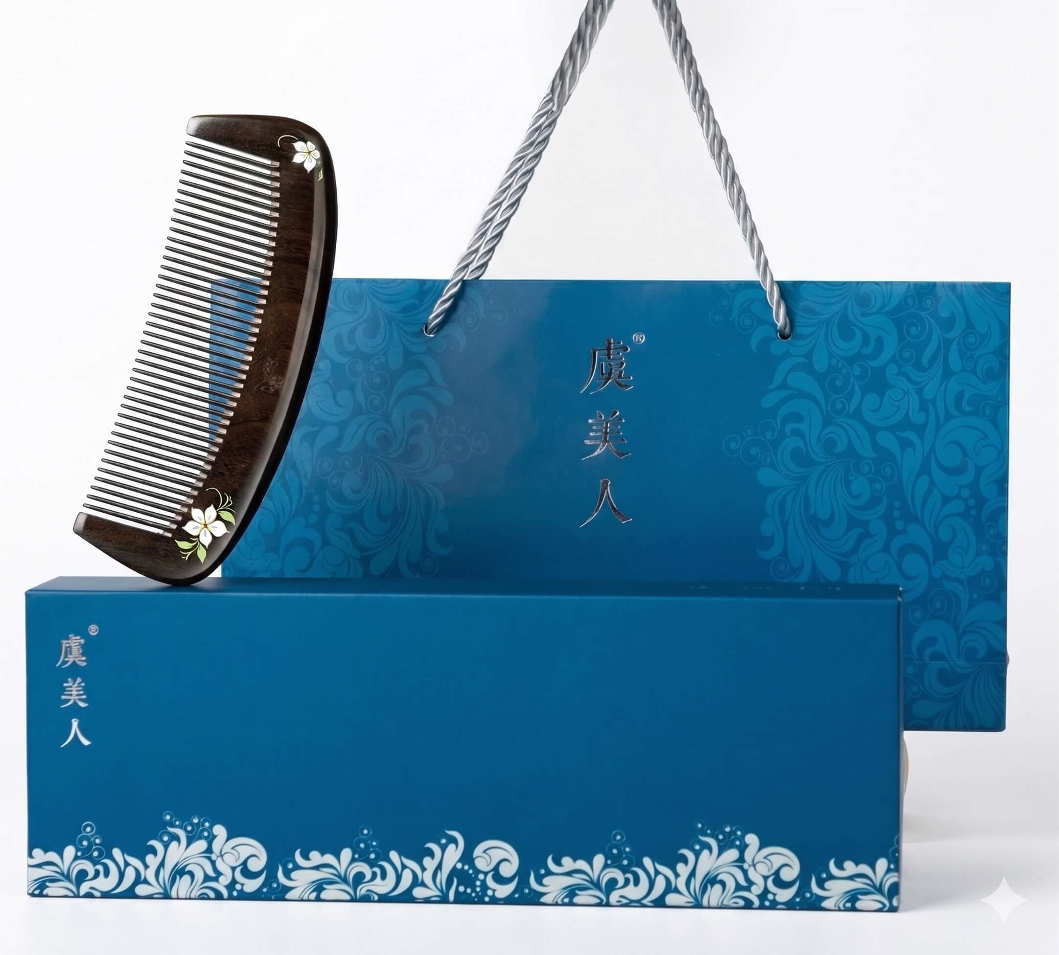 Black comb on a blue decorative box with floral patterns