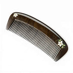 Wooden comb with floral design on a white background