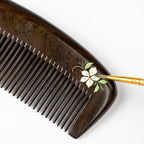 Wooden comb with floral design on a white background