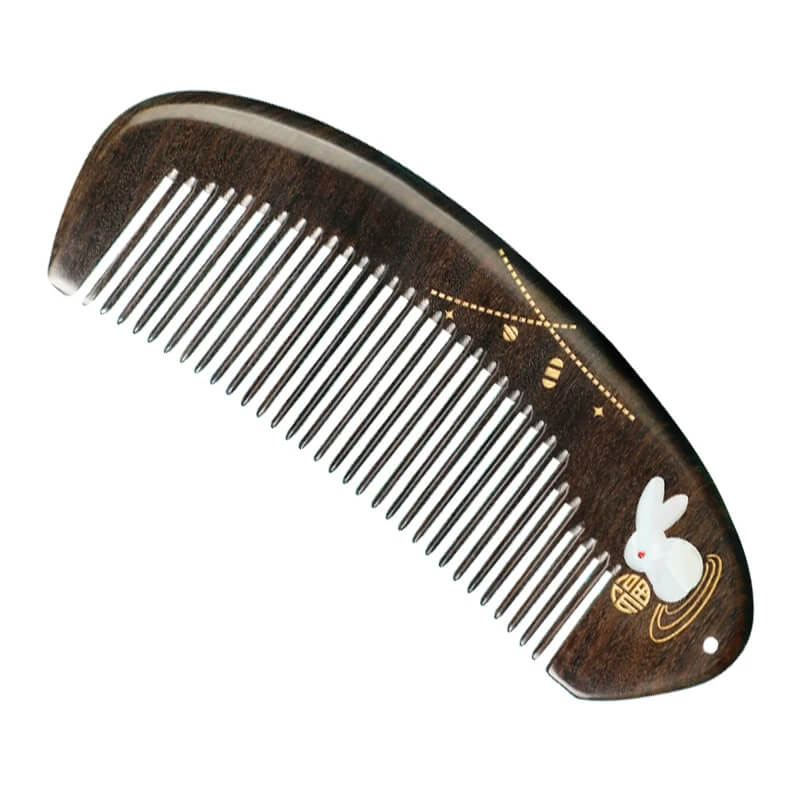 Wooden comb with a rabbit design on a white background