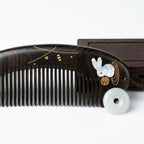 Decorative comb with rabbit design on a white background