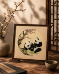 Panda silk embroidery artwork displayed in a wooden frame table stand