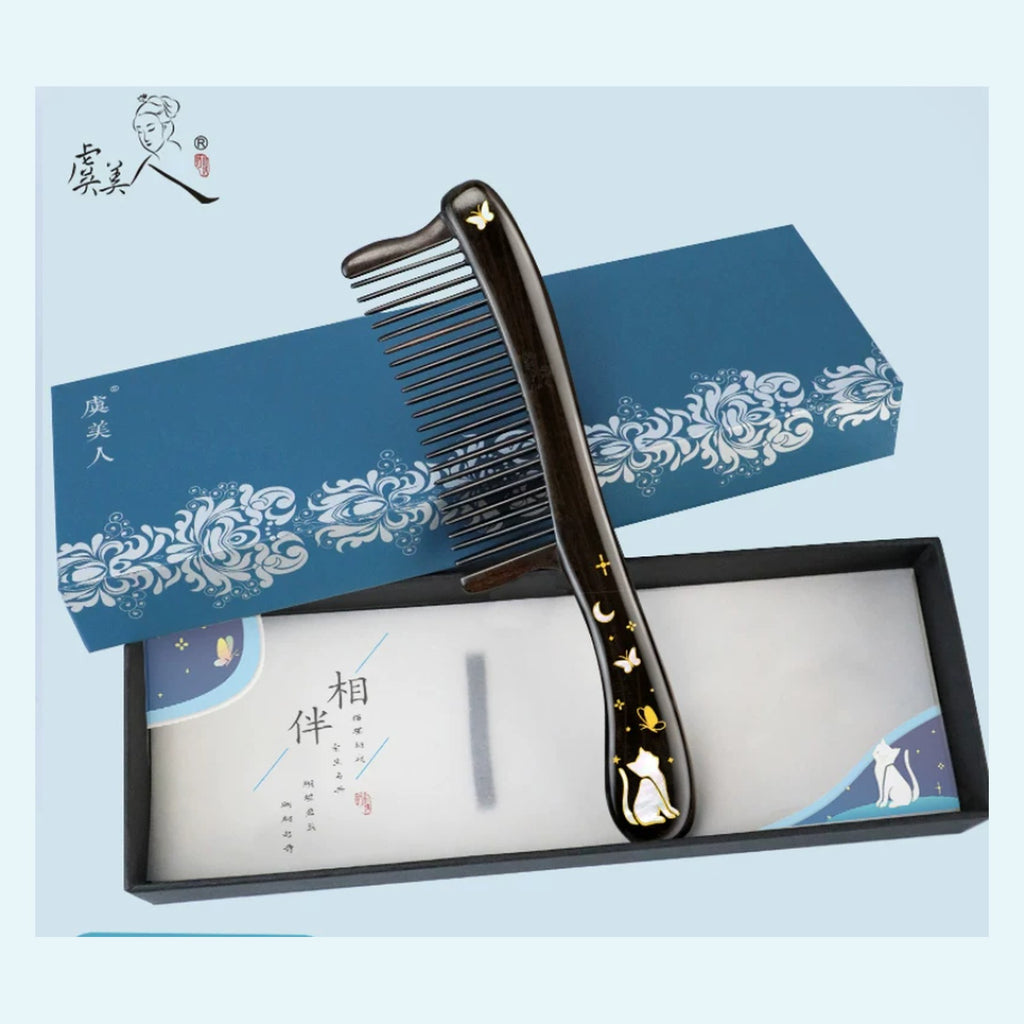 Black ebony wood cat comb displayed with blue gift box packaging
