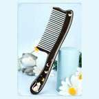 Black ebony wood cat comb styled with daisies and soft blue decor
