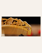 Close-up of plum blossom carving on a handmade wooden comb
