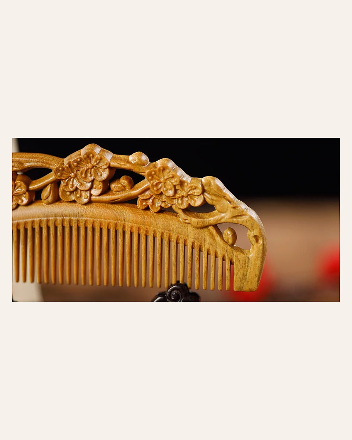 Close-up of plum blossom carving on a handmade wooden comb
