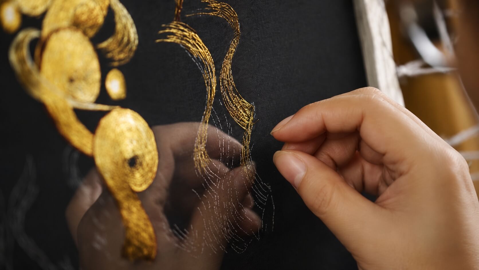 Chinese artisan creating handmade silk embroidery