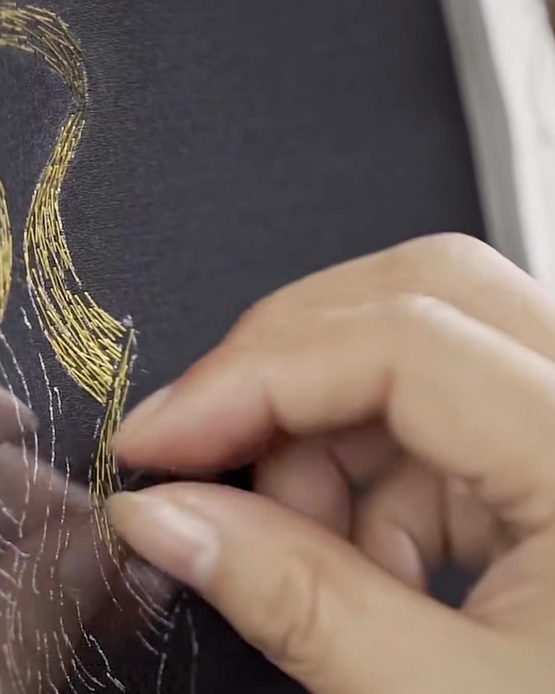 Close-up of an artisan creating Changzhou Random Stitch Embroidery using fine silk threads, a Chinese intangible cultural heritage craft